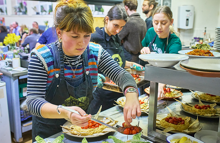 Volunteers prepare food at a Food Works bistro night