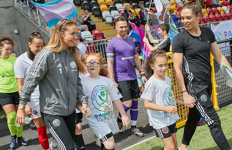 Members of Sheffield United's women's squad lead the teams out